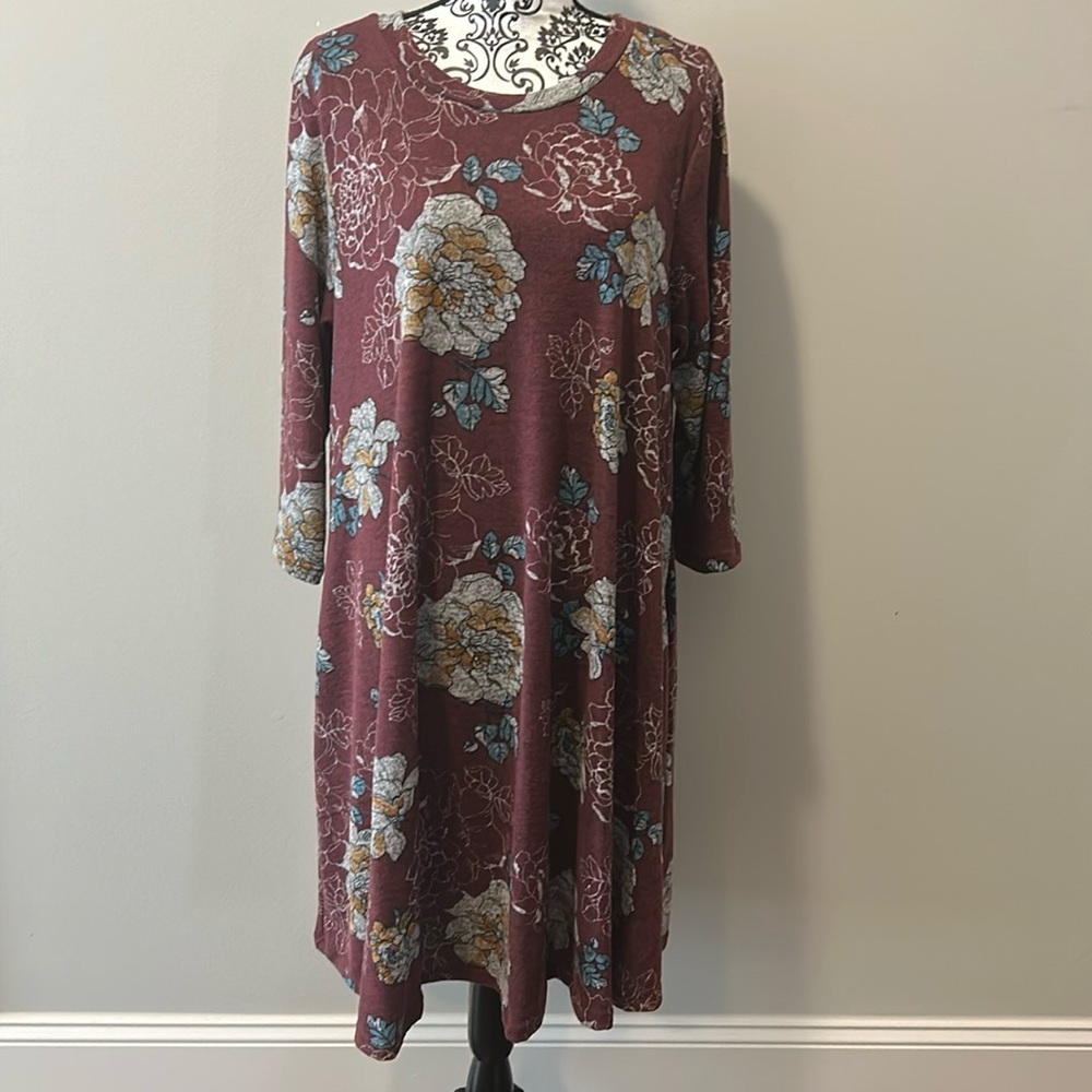 NWOT. Woman’s long sleeve mid dress with floral pattern on burgundy background